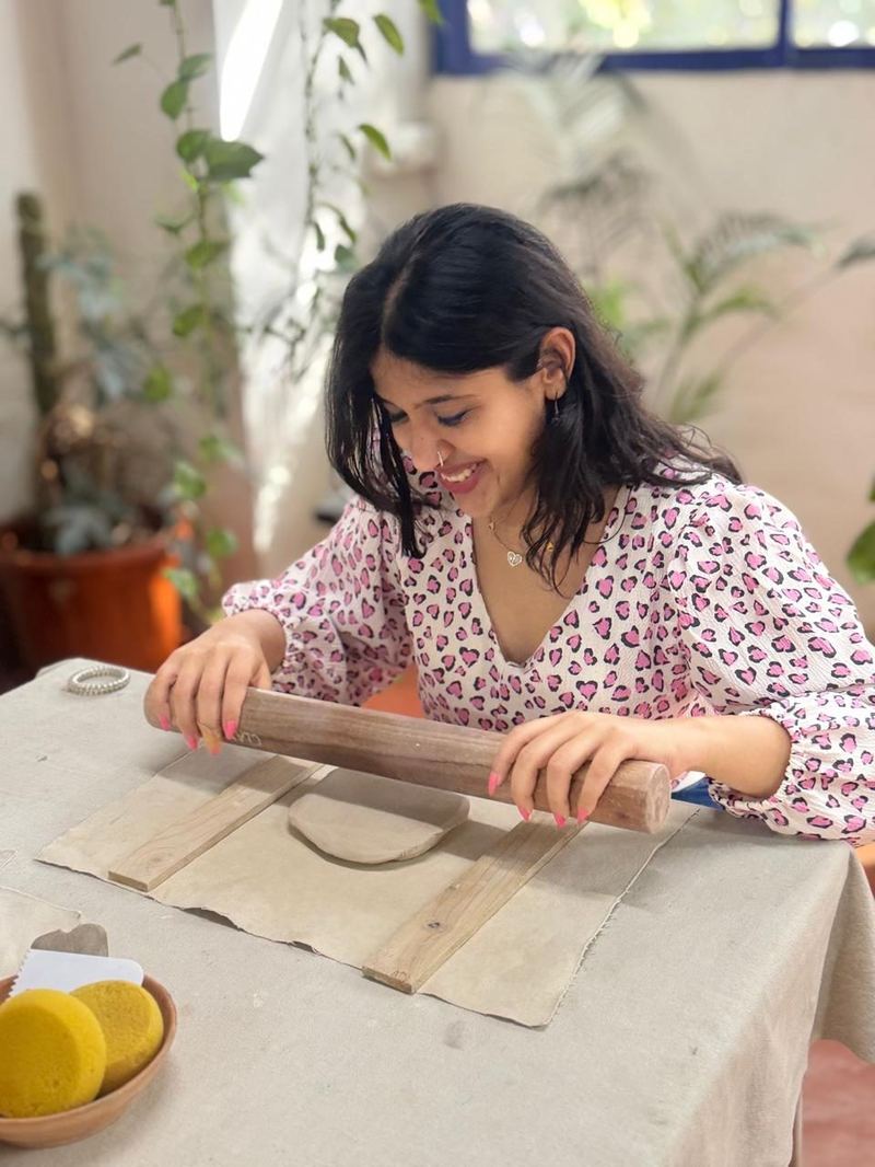 Student rolling clay slab at Mudcast