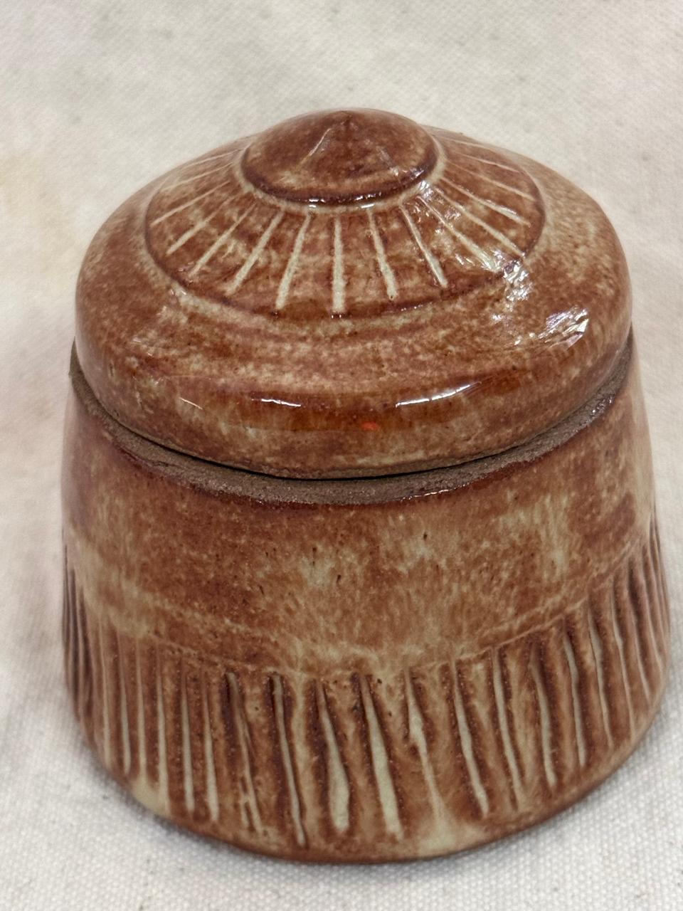 Lidded jar with terracotta glaze and carved lines — Meeta Pant