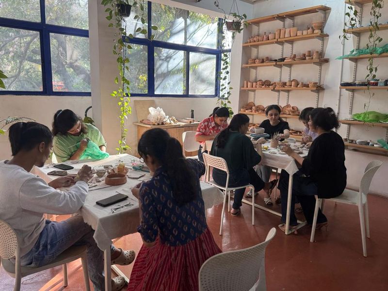 Hand painting clay plate at Mudcast
