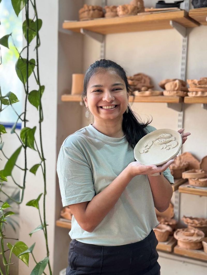 Happy student with finished piece Mudcast