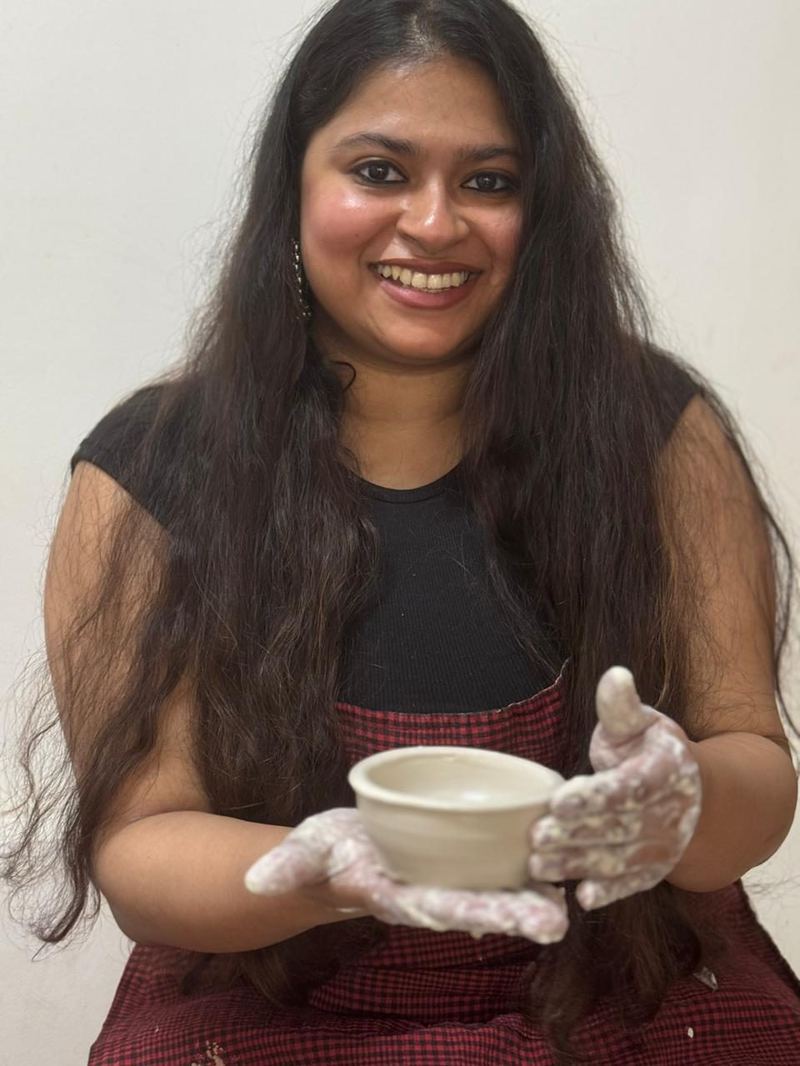 Student with finished pottery bowl Mudcast